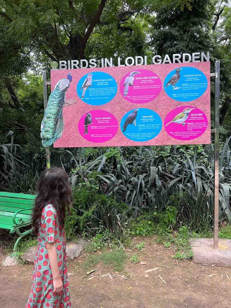 Mimi looking at Bird sign in Lodhi Gardens, New Delhi, India